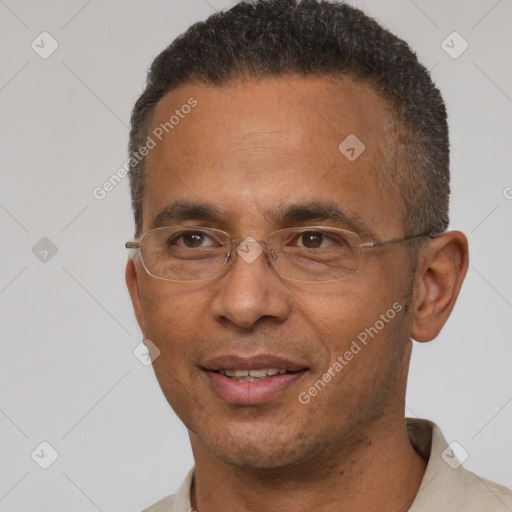 Joyful black adult male with short  brown hair and brown eyes