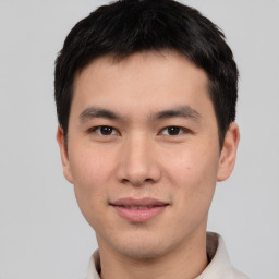 Joyful asian young-adult male with short  black hair and brown eyes