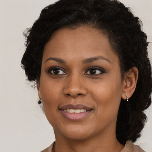 Joyful black young-adult female with medium  brown hair and brown eyes