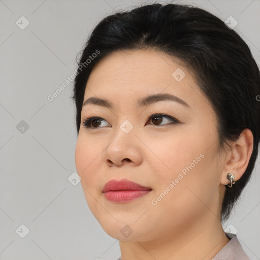 Joyful asian young-adult female with medium  brown hair and brown eyes