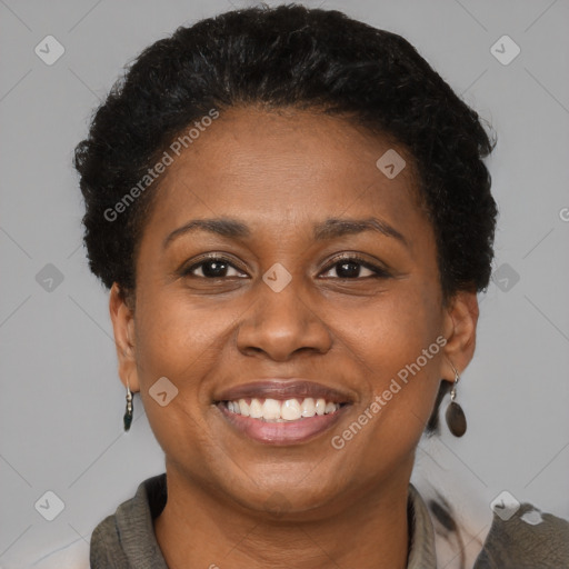 Joyful black adult female with short  brown hair and brown eyes