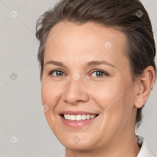 Joyful white adult female with short  brown hair and brown eyes