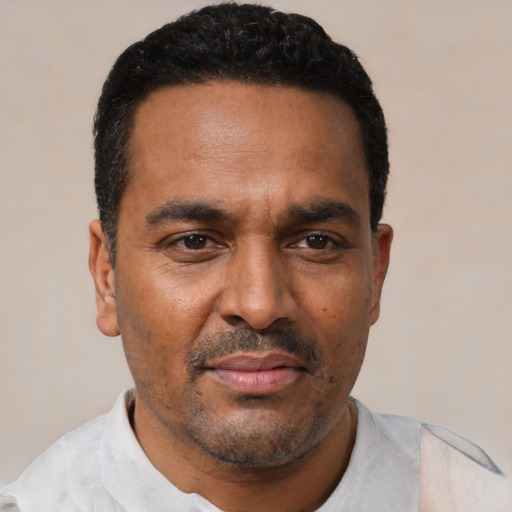Neutral latino adult male with short  black hair and brown eyes