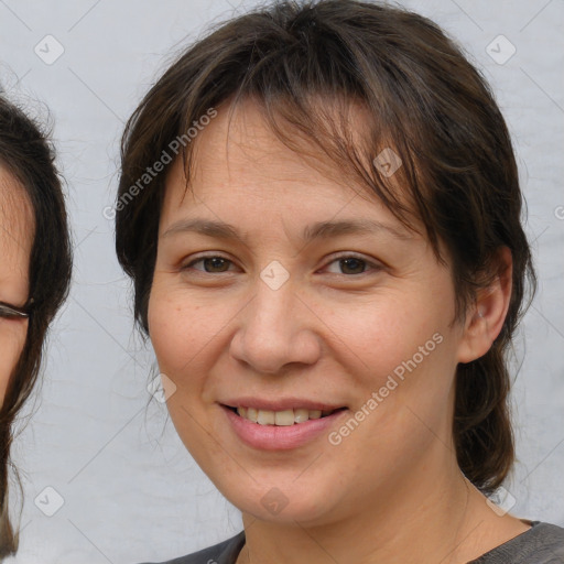 Joyful white adult female with medium  brown hair and brown eyes