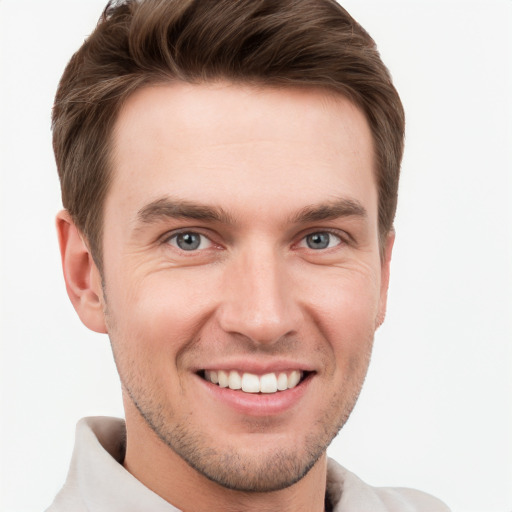 Joyful white young-adult male with short  brown hair and grey eyes