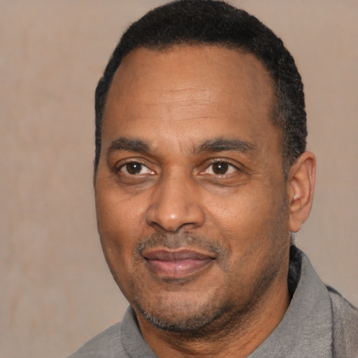 Joyful latino adult male with short  black hair and brown eyes