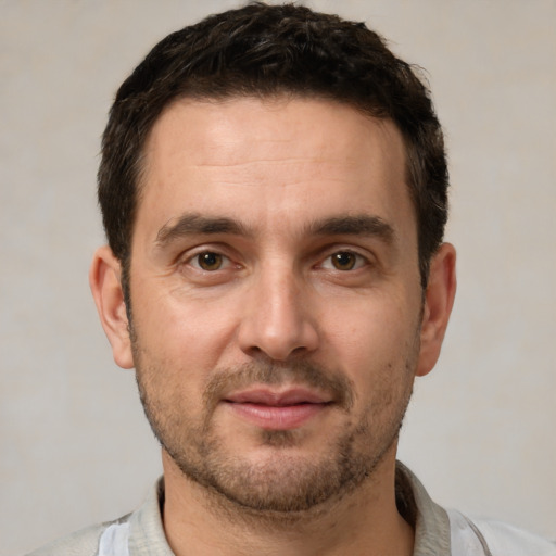 Joyful white adult male with short  brown hair and brown eyes