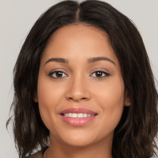 Joyful white young-adult female with long  brown hair and brown eyes