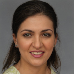 Joyful white young-adult female with medium  brown hair and brown eyes