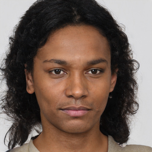 Neutral black young-adult female with long  brown hair and brown eyes
