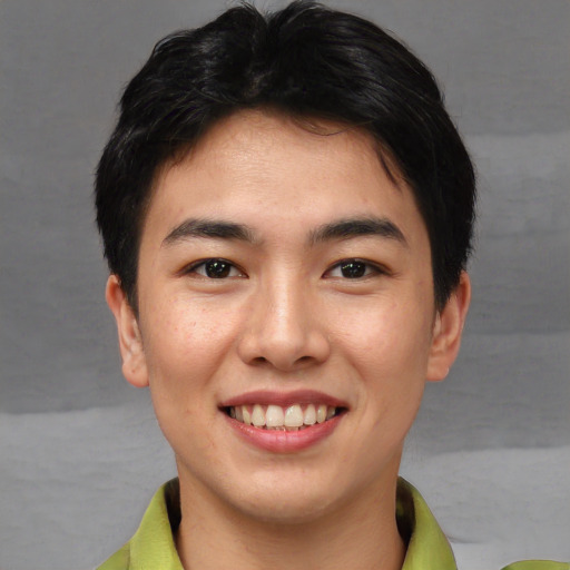 Joyful asian young-adult male with short  brown hair and brown eyes