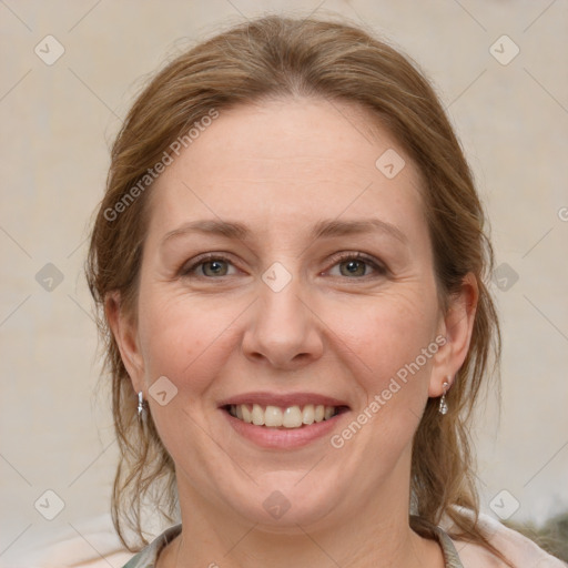 Joyful white adult female with medium  brown hair and grey eyes