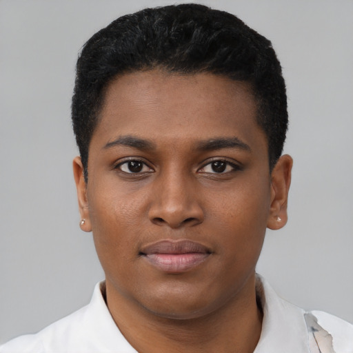 Joyful black young-adult male with short  black hair and brown eyes