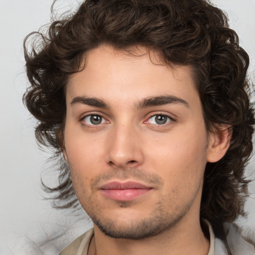 Joyful white young-adult male with medium  brown hair and brown eyes