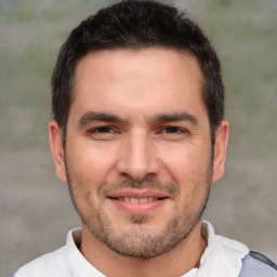 Joyful white adult male with short  brown hair and brown eyes