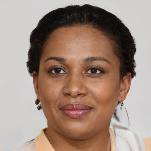 Joyful latino adult female with short  brown hair and brown eyes