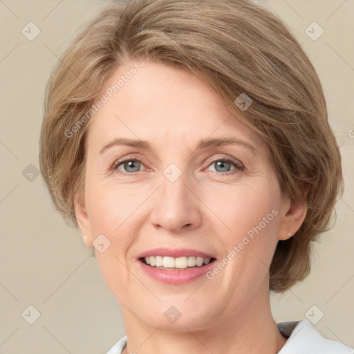 Joyful white young-adult female with medium  brown hair and green eyes