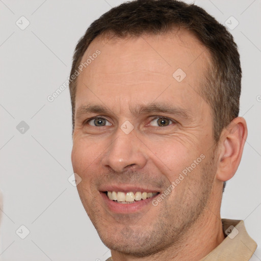 Joyful white adult male with short  brown hair and brown eyes