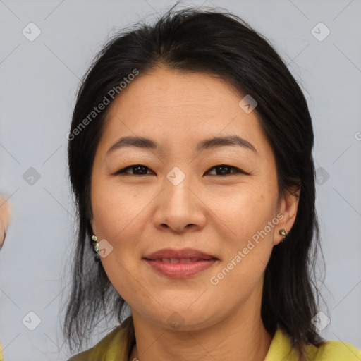 Joyful asian adult female with medium  brown hair and brown eyes