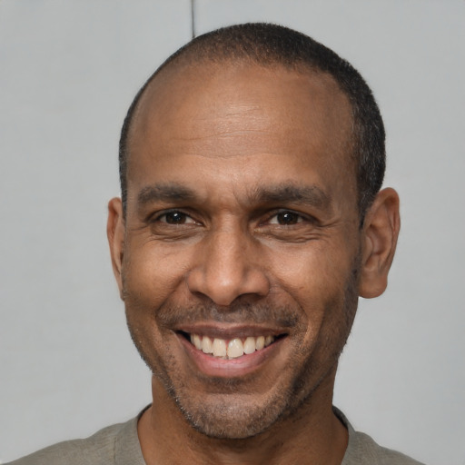 Joyful latino adult male with short  black hair and brown eyes