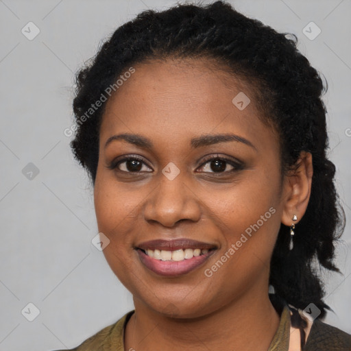 Joyful black young-adult female with long  brown hair and brown eyes