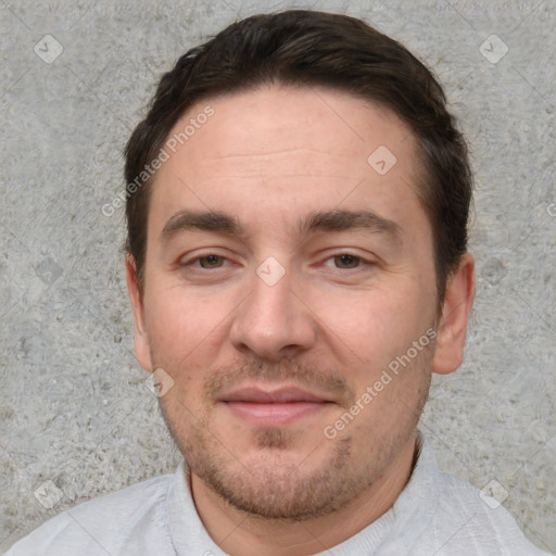 Joyful white adult male with short  brown hair and brown eyes