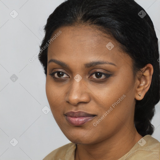 Joyful black young-adult female with long  black hair and brown eyes