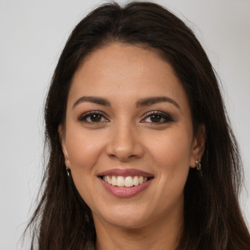 Joyful white young-adult female with long  brown hair and brown eyes