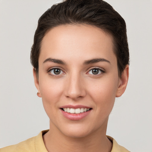 Joyful white young-adult female with short  brown hair and brown eyes