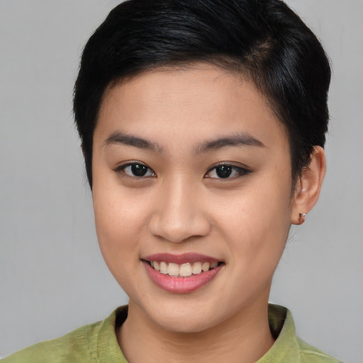 Joyful asian young-adult female with short  brown hair and brown eyes