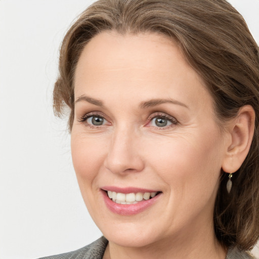 Joyful white adult female with medium  brown hair and grey eyes