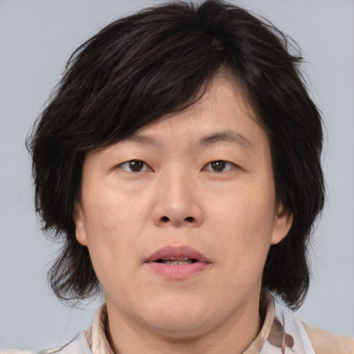 Joyful asian adult male with medium  brown hair and brown eyes