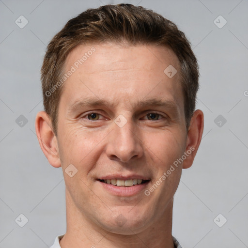 Joyful white adult male with short  brown hair and brown eyes