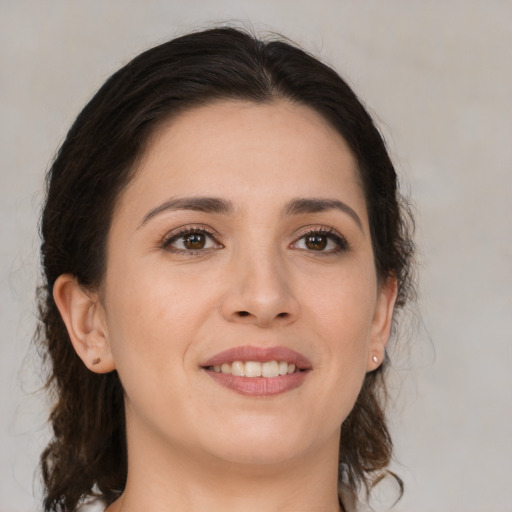 Joyful white young-adult female with medium  brown hair and brown eyes