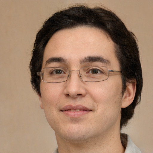 Joyful white adult male with medium  brown hair and brown eyes