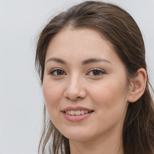 Joyful white young-adult female with long  brown hair and grey eyes