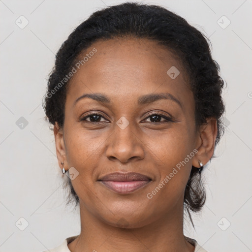 Joyful black adult female with medium  brown hair and brown eyes