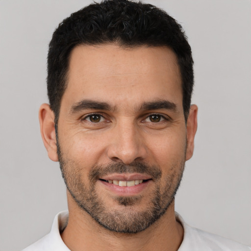 Joyful white young-adult male with short  black hair and brown eyes