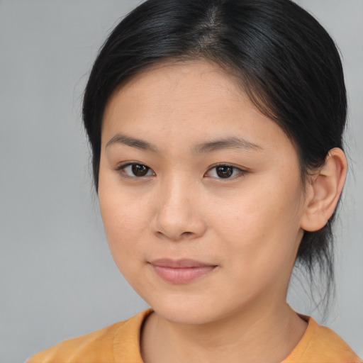 Joyful asian young-adult female with medium  brown hair and brown eyes