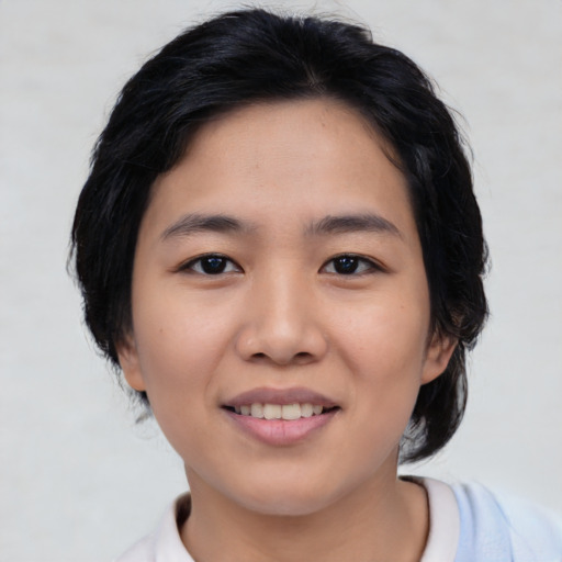 Joyful asian young-adult female with medium  black hair and brown eyes