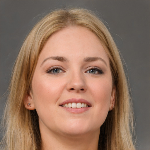 Joyful white young-adult female with long  brown hair and grey eyes