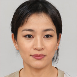 Joyful asian young-adult female with medium  brown hair and brown eyes