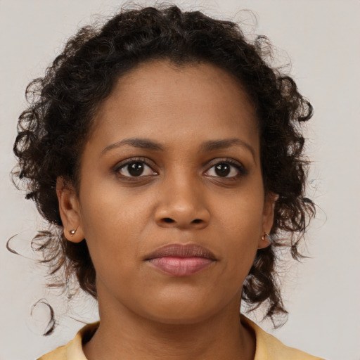 Neutral black young-adult female with medium  brown hair and brown eyes