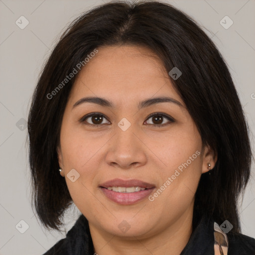 Joyful latino adult female with medium  brown hair and brown eyes