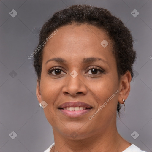 Joyful black adult female with short  brown hair and brown eyes