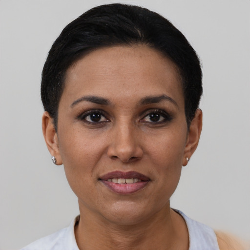 Joyful latino adult female with short  black hair and brown eyes