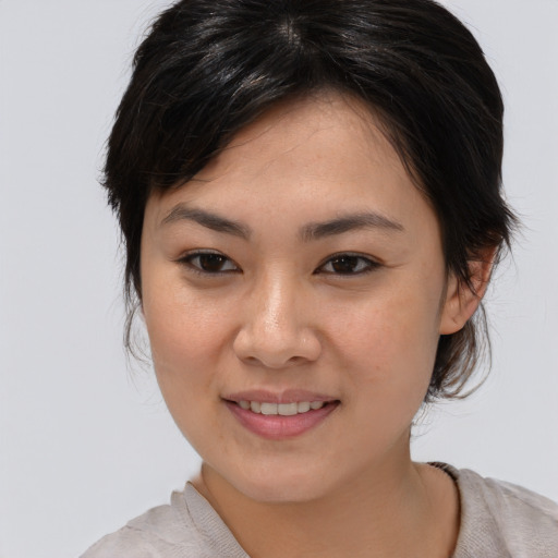 Joyful asian young-adult female with medium  brown hair and brown eyes