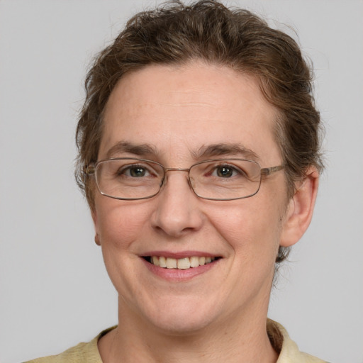 Joyful white adult female with short  brown hair and grey eyes