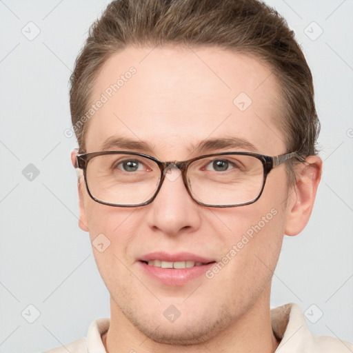 Joyful white adult male with short  brown hair and grey eyes