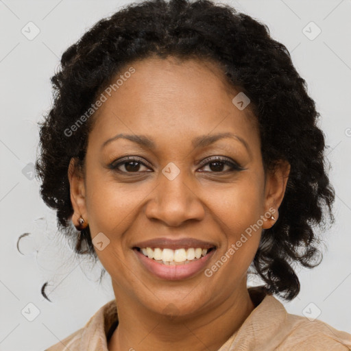 Joyful black adult female with medium  brown hair and brown eyes